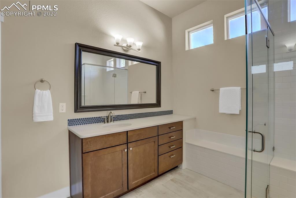 1435 Catnap Lane Monument, CO 80132 - Photo 17 of 47 a bathroom with a sink vanity mirror and shower
