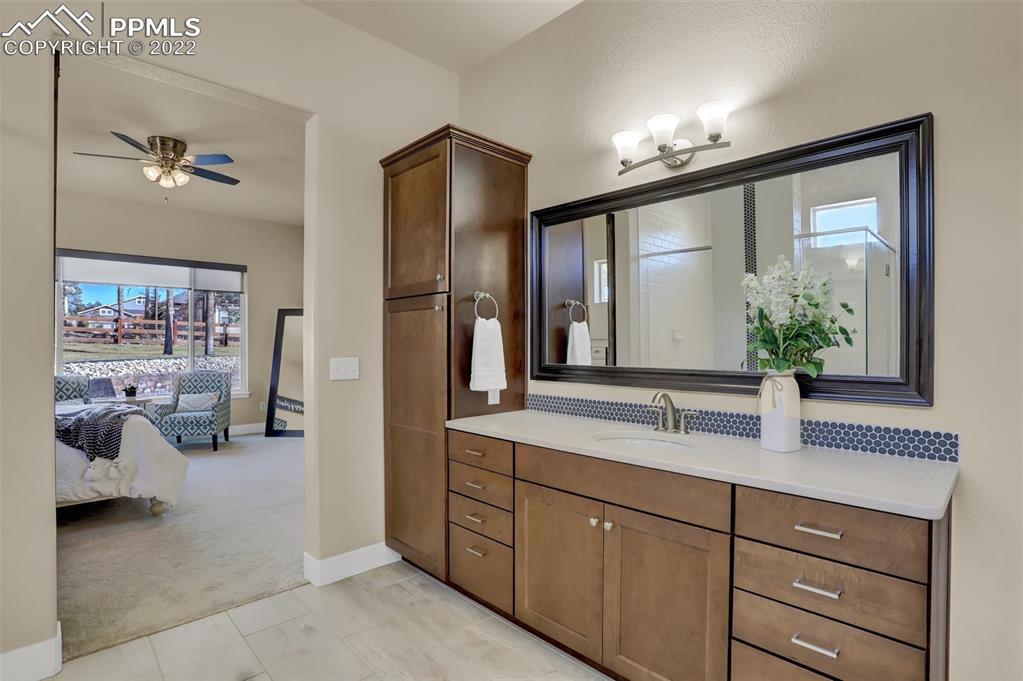 1435 Catnap Lane Monument, CO 80132 - Photo 18 of 47 a bathroom with a double vanity sink and a mirror