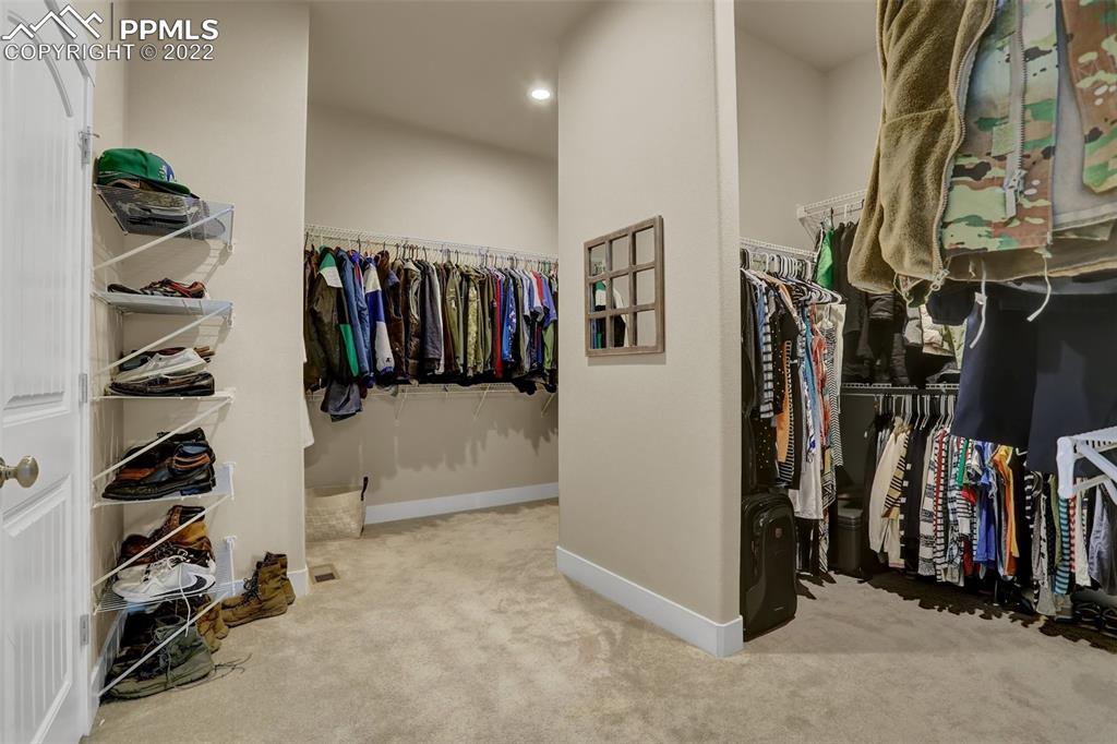 1435 Catnap Lane Monument, CO 80132 - Photo 19 of 47 a view of walk in closet with clothes and shoes