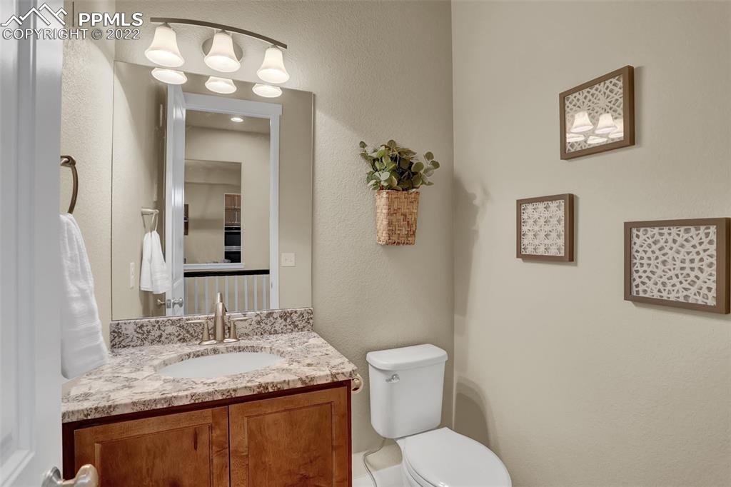 1435 Catnap Lane Monument, CO 80132 - Photo 22 of 47 a bathroom with a granite countertop toilet sink and mirror
