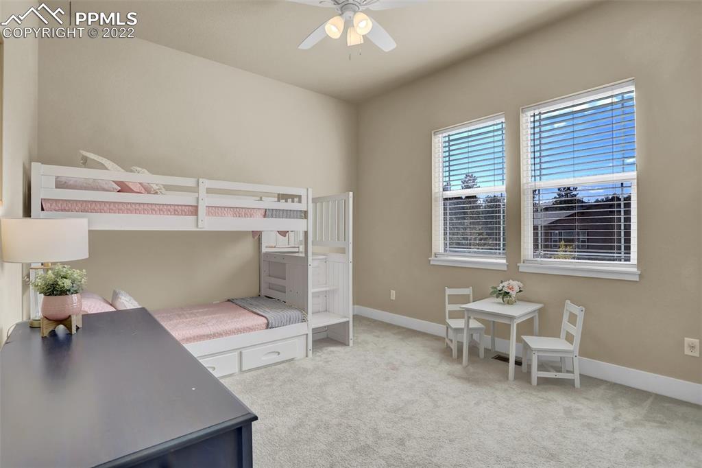 1435 Catnap Lane Monument, CO 80132 - Photo 23 of 47 a living room with furniture and a chandelier