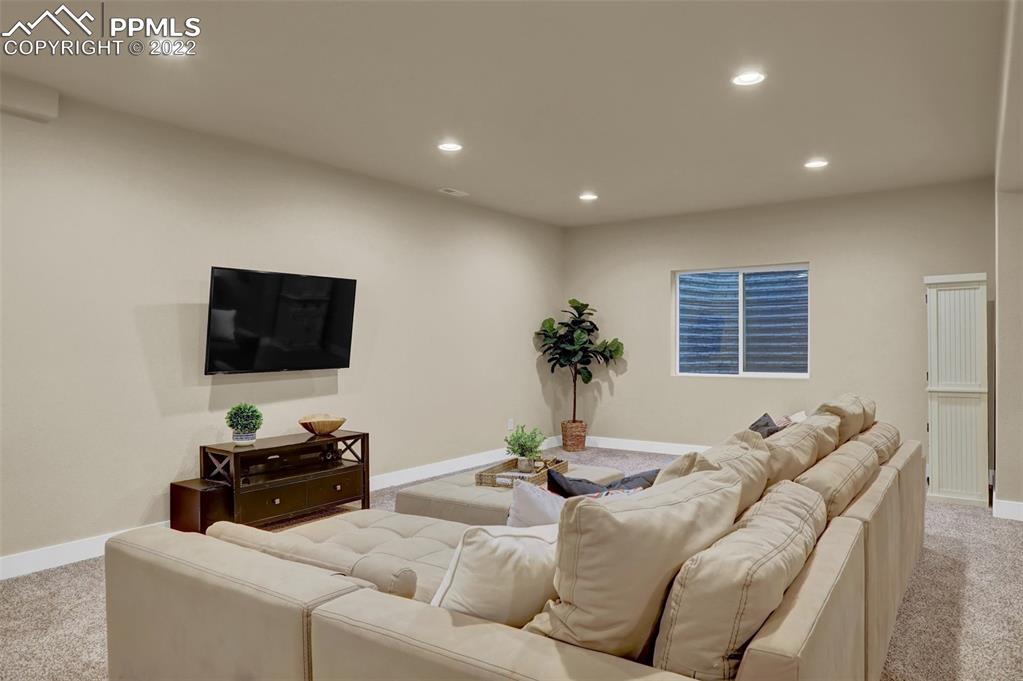 1435 Catnap Lane Monument, CO 80132 - Photo 31 of 47 a living room with furniture and a flat screen tv