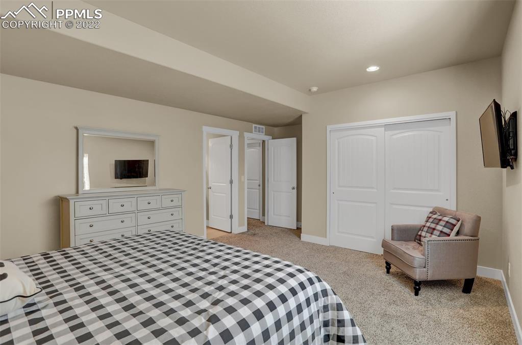 1435 Catnap Lane Monument, CO 80132 - Photo 34 of 47 a bedroom with a bed and a couch