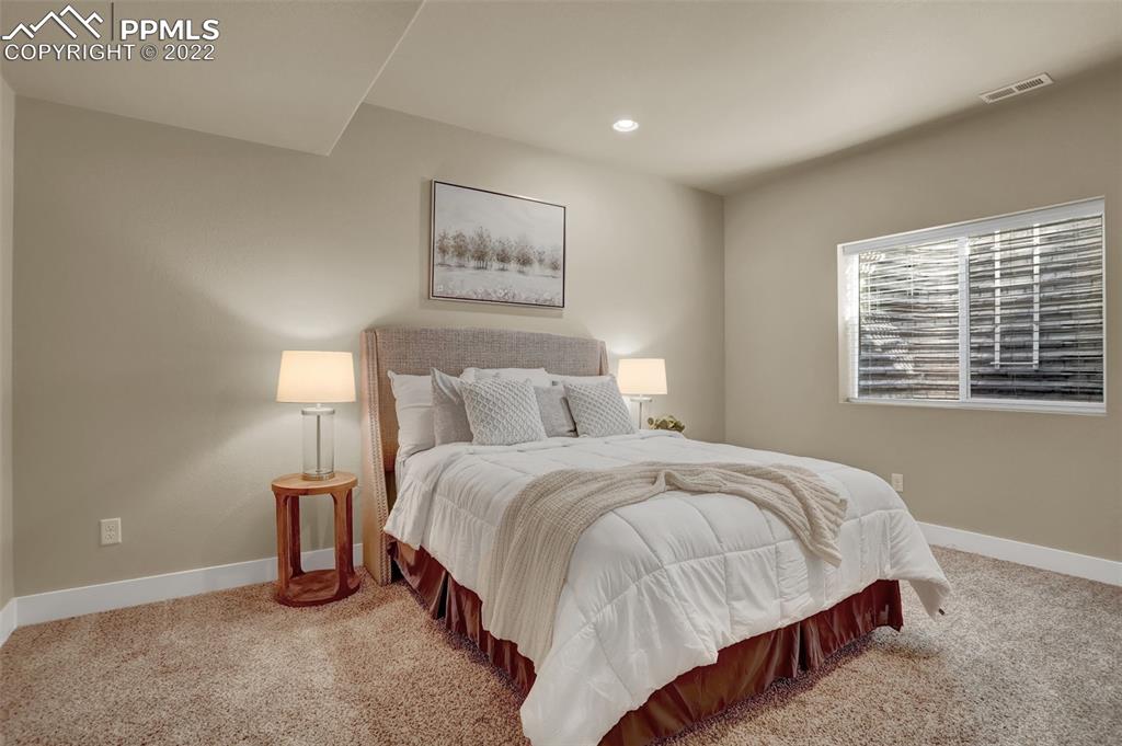 1435 Catnap Lane Monument, CO 80132 - Photo 36 of 47 a bedroom with bed and a window