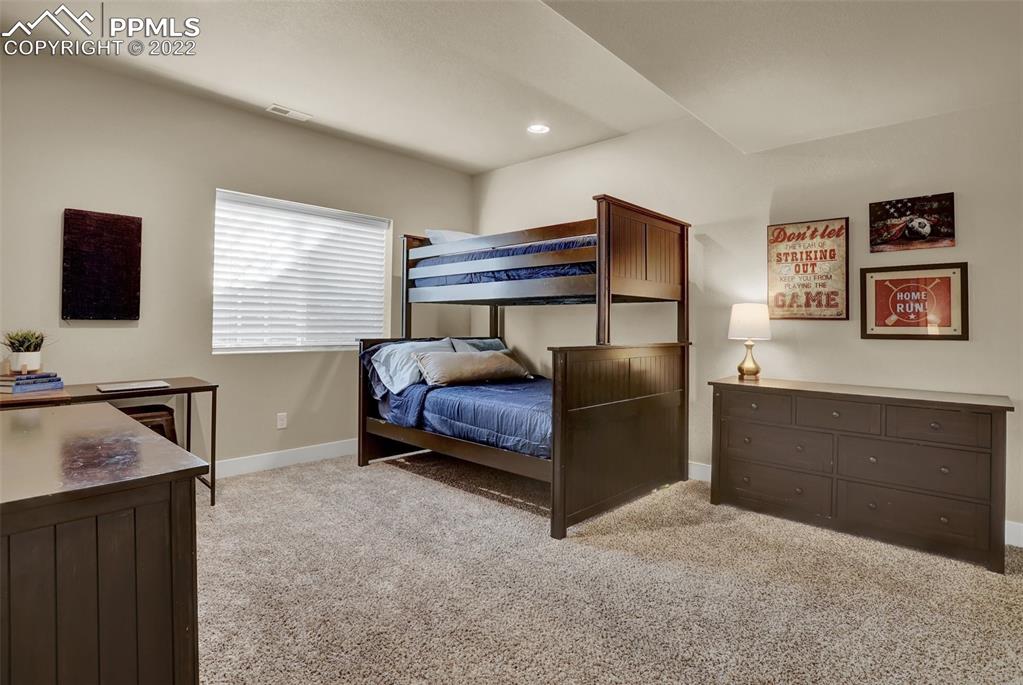 1435 Catnap Lane Monument, CO 80132 - Photo 39 of 47 a bedroom with a bed and a dresser