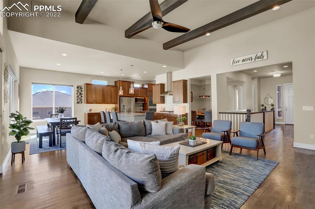 1435 Catnap Lane Monument, CO 80132 - Photo 6 of 47 a living room with furniture kitchen view and a wooden floor