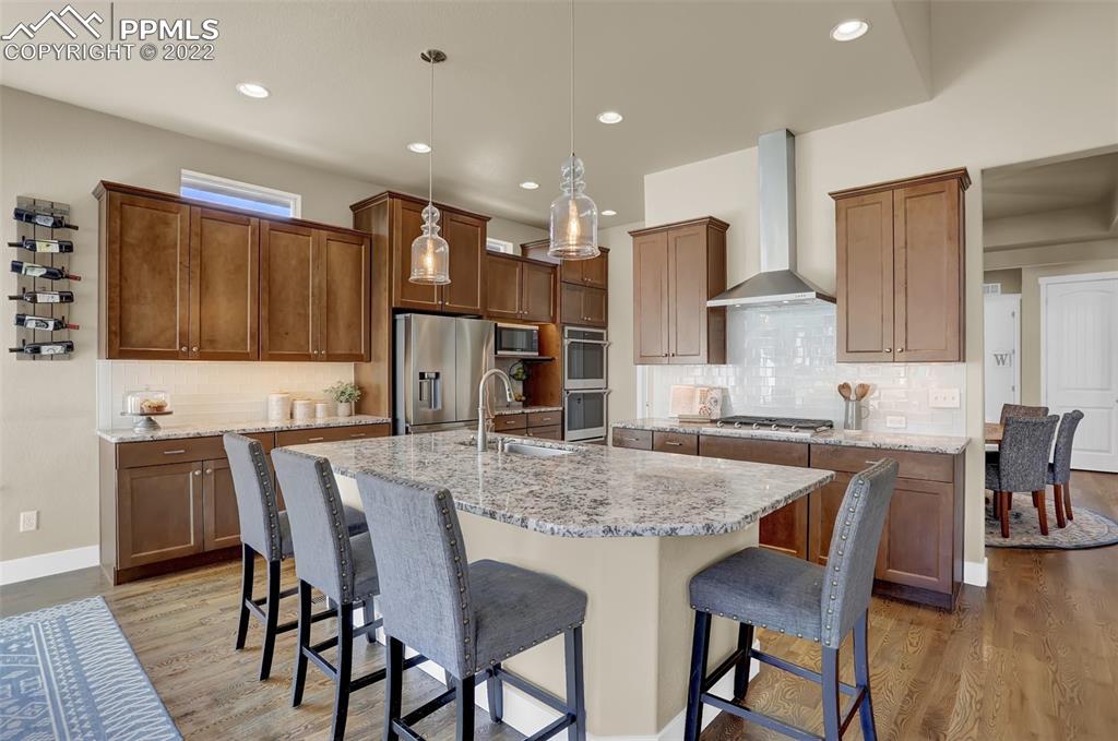 1435 Catnap Lane Monument, CO 80132 - Photo 9 of 47 a large kitchen with a table and chairs in it