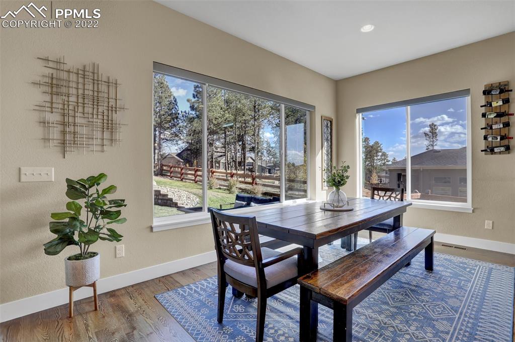 1435 Catnap Lane Monument, CO 80132 - Photo 10 of 47 a view of a dining room with furniture window and wooden floor