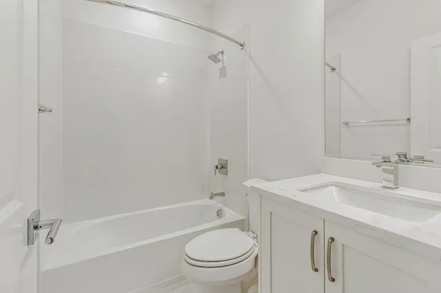 a bathroom with a sink a toilet and a bathtub