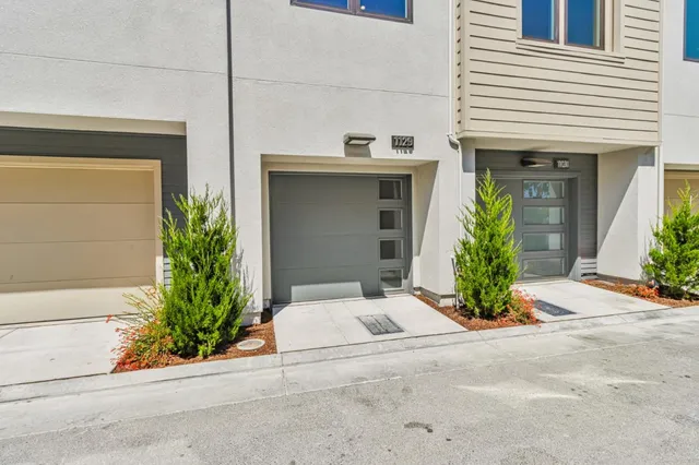a view of a house with potted plants