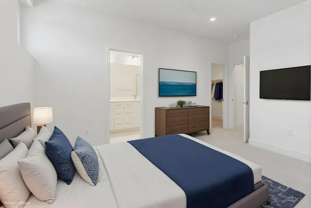 a bedroom with a bed and a flat screen tv