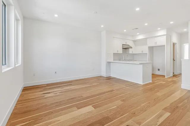 a view of a kitchen with a sink and cabinets