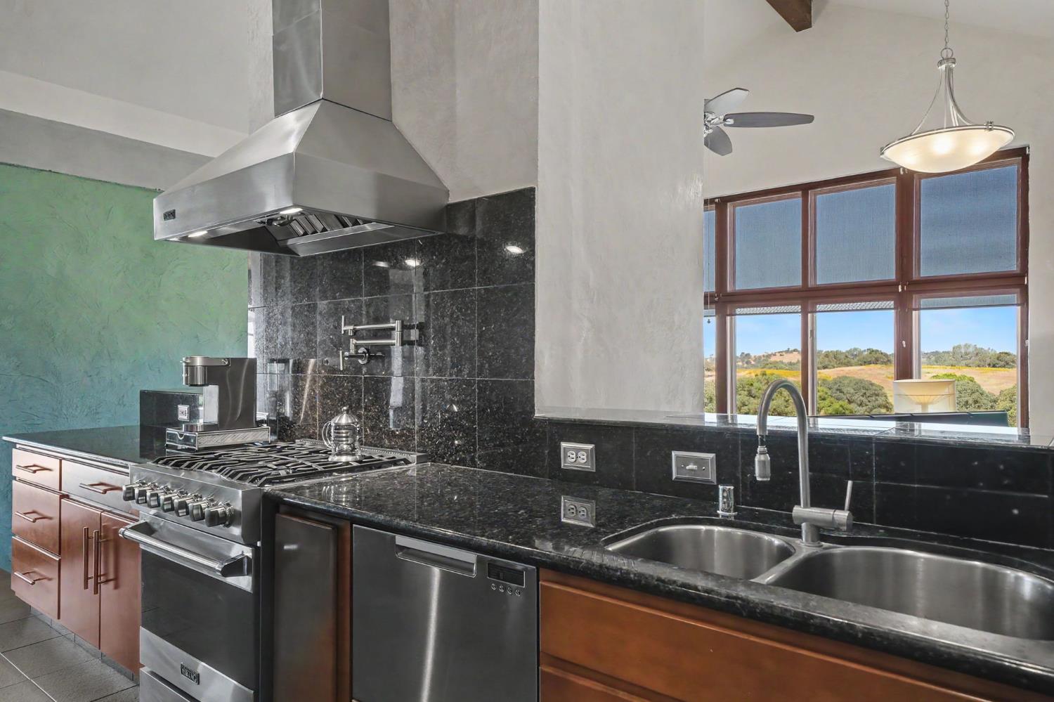 15070 Willow Creek Road Ione, CA 95640 - Photo 34 of 66 a kitchen with stainless steel appliances granite countertop a sink and a stove