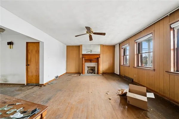 a living room with furniture and a ceiling fan