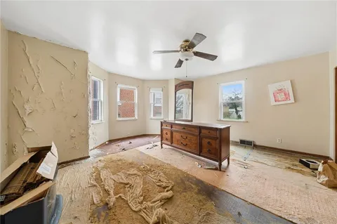 a spacious bedroom with a bed and a dresser