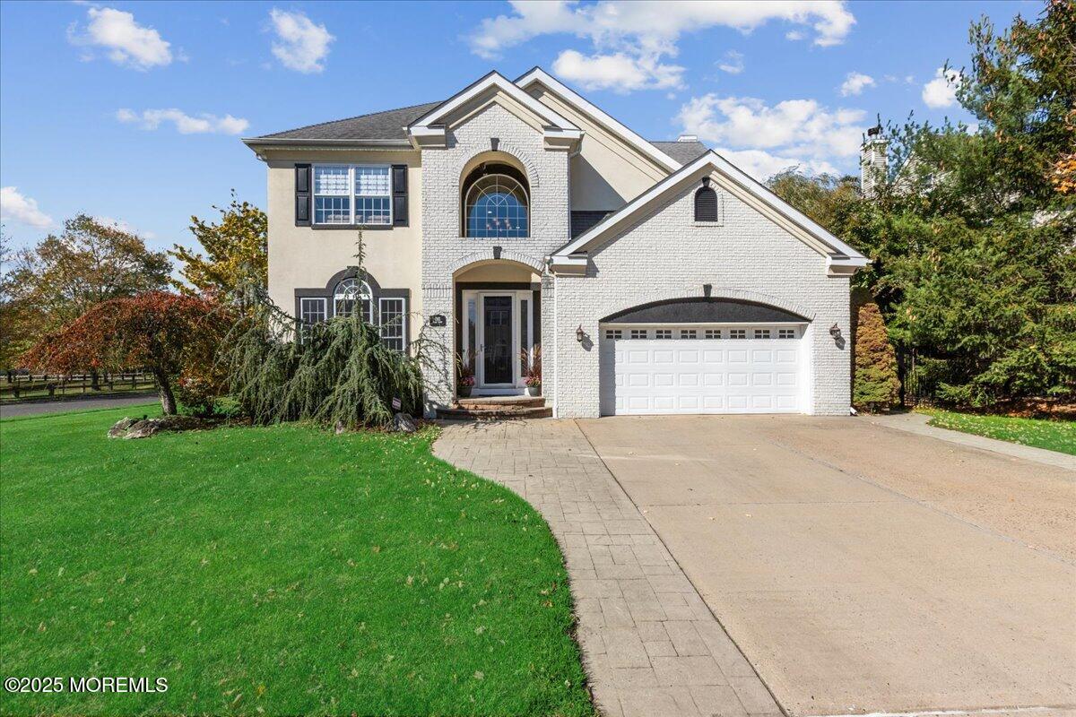 a front view of a house with a yard and garage