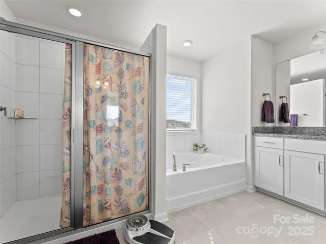 a bathroom with a bathtub and a shower