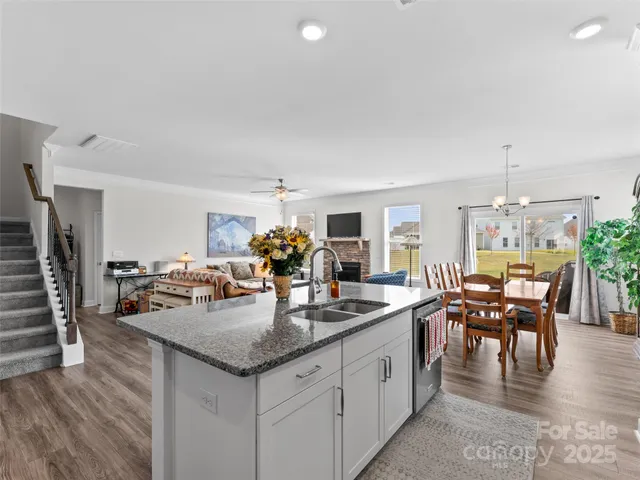 a kitchen with granite countertop kitchen island stainless steel appliances a table and chairs