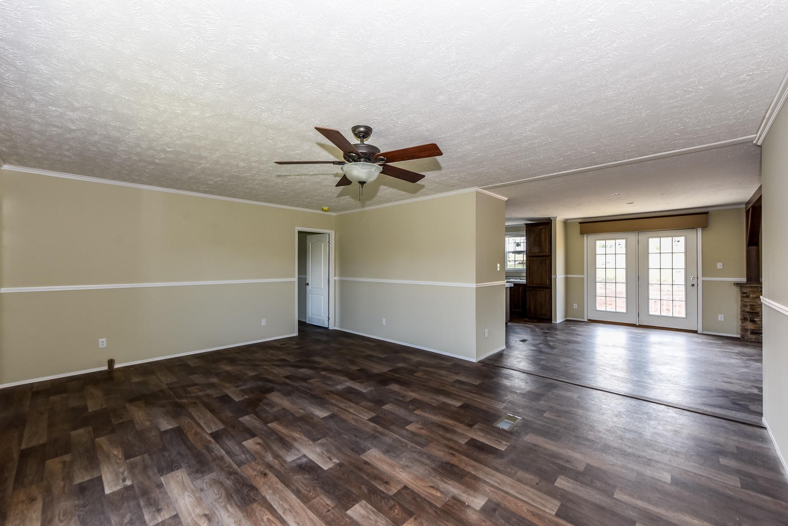 207 South Springview Road Maryville, TN 37801 - Photo 6 of 34 a view of a livingroom with wooden floor and a ceiling fan
