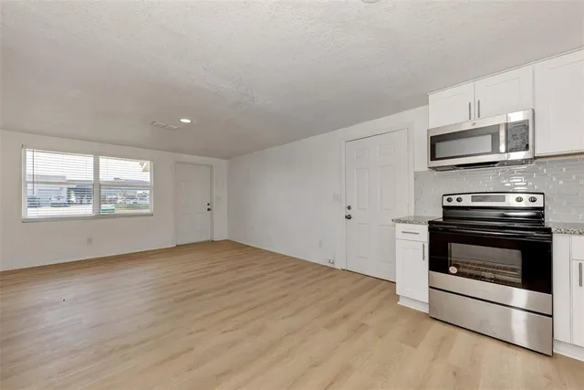 a view of kitchen with microwave and stove