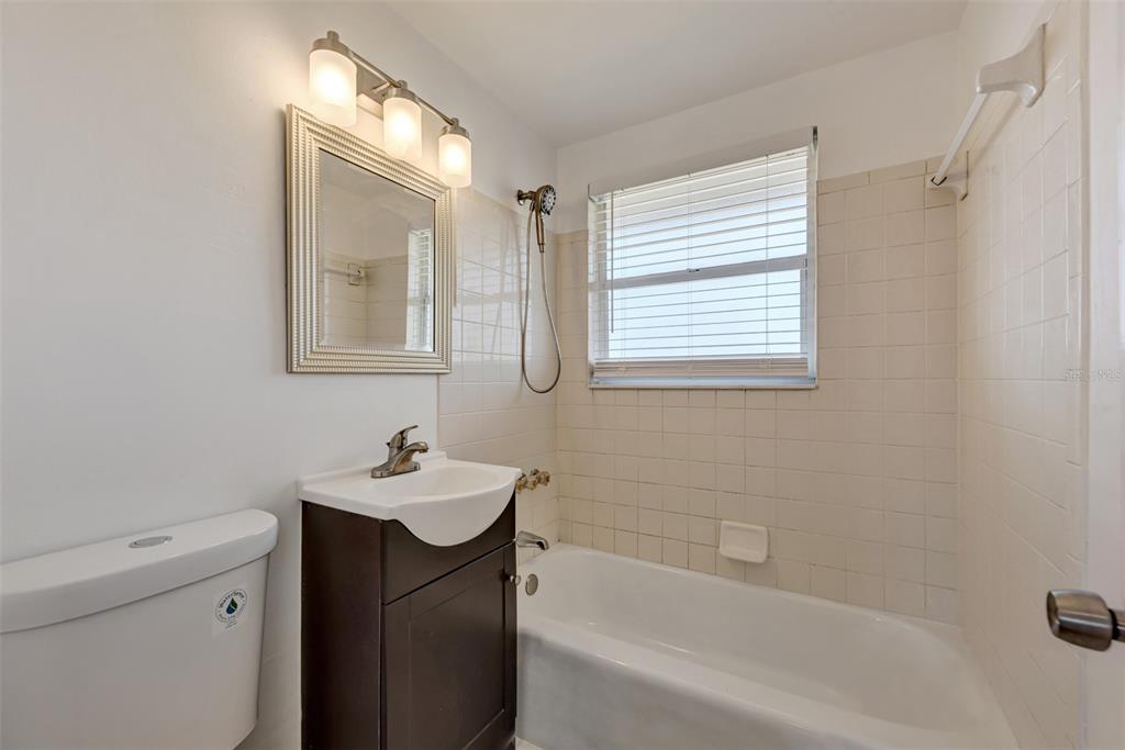 1601 Faust Drive, Unit B Englewood, FL 34224 - Photo 7 of 19 a bathroom with a sink a toilet and shower