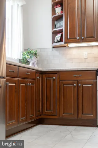 a kitchen with granite countertop white cabinets and black door