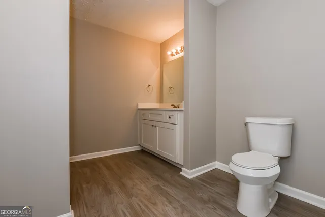 a bathroom with a toilet sink and a mirror
