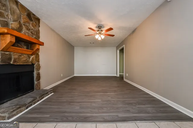 a view of an empty room with a fireplace