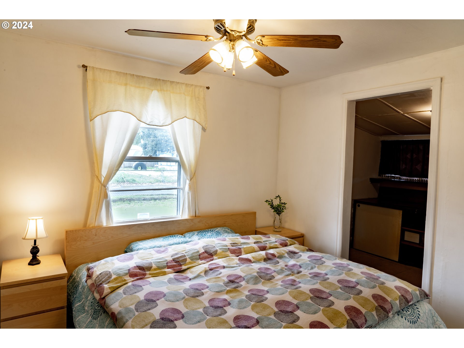 17141 Southeast Stephens Street Portland, OR 97233 - Photo 13 of 27 a bedroom with a bed and a chandelier