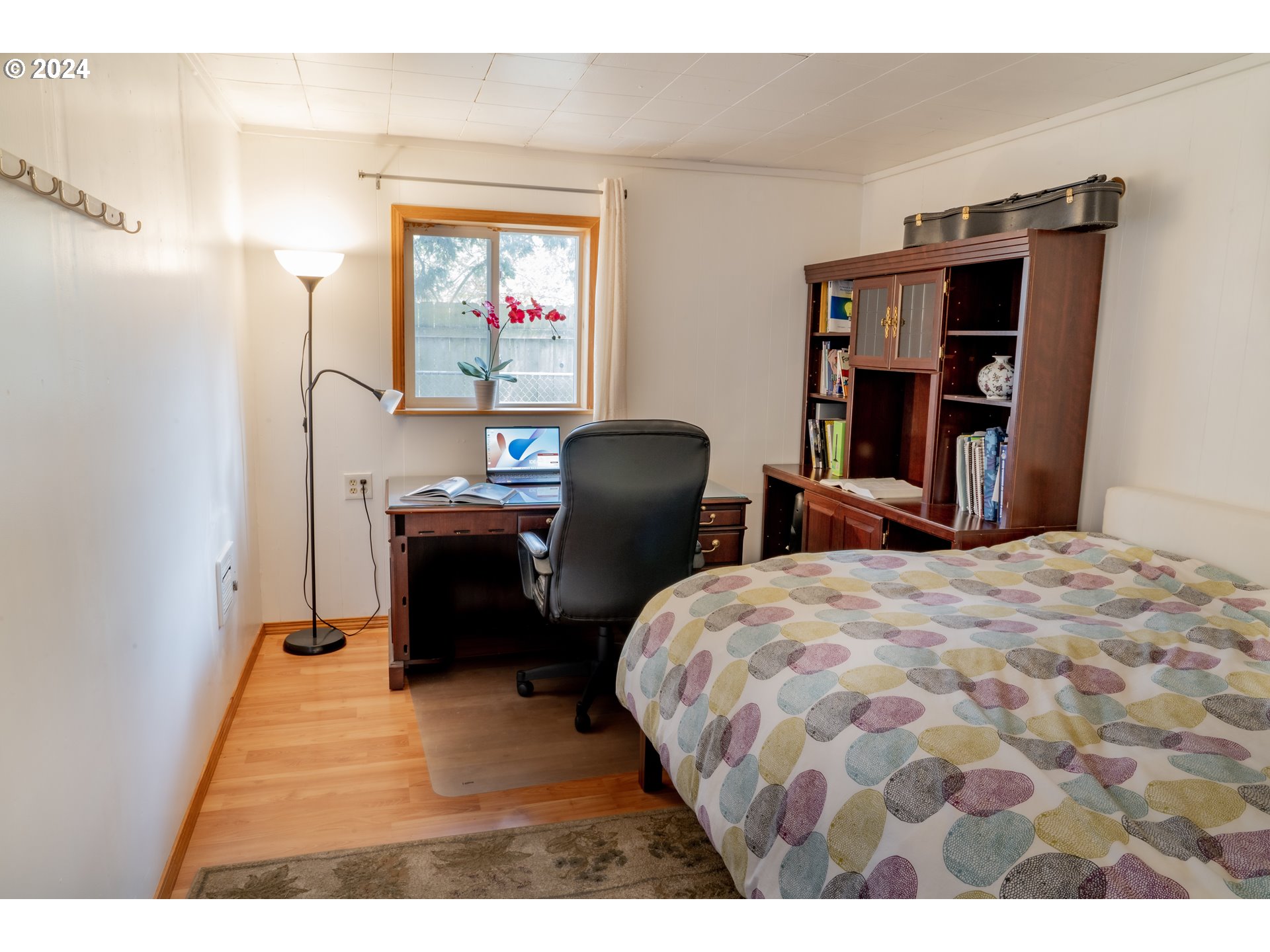 17141 Southeast Stephens Street Portland, OR 97233 - Photo 19 of 27 a bedroom with a bed and a bookshelf