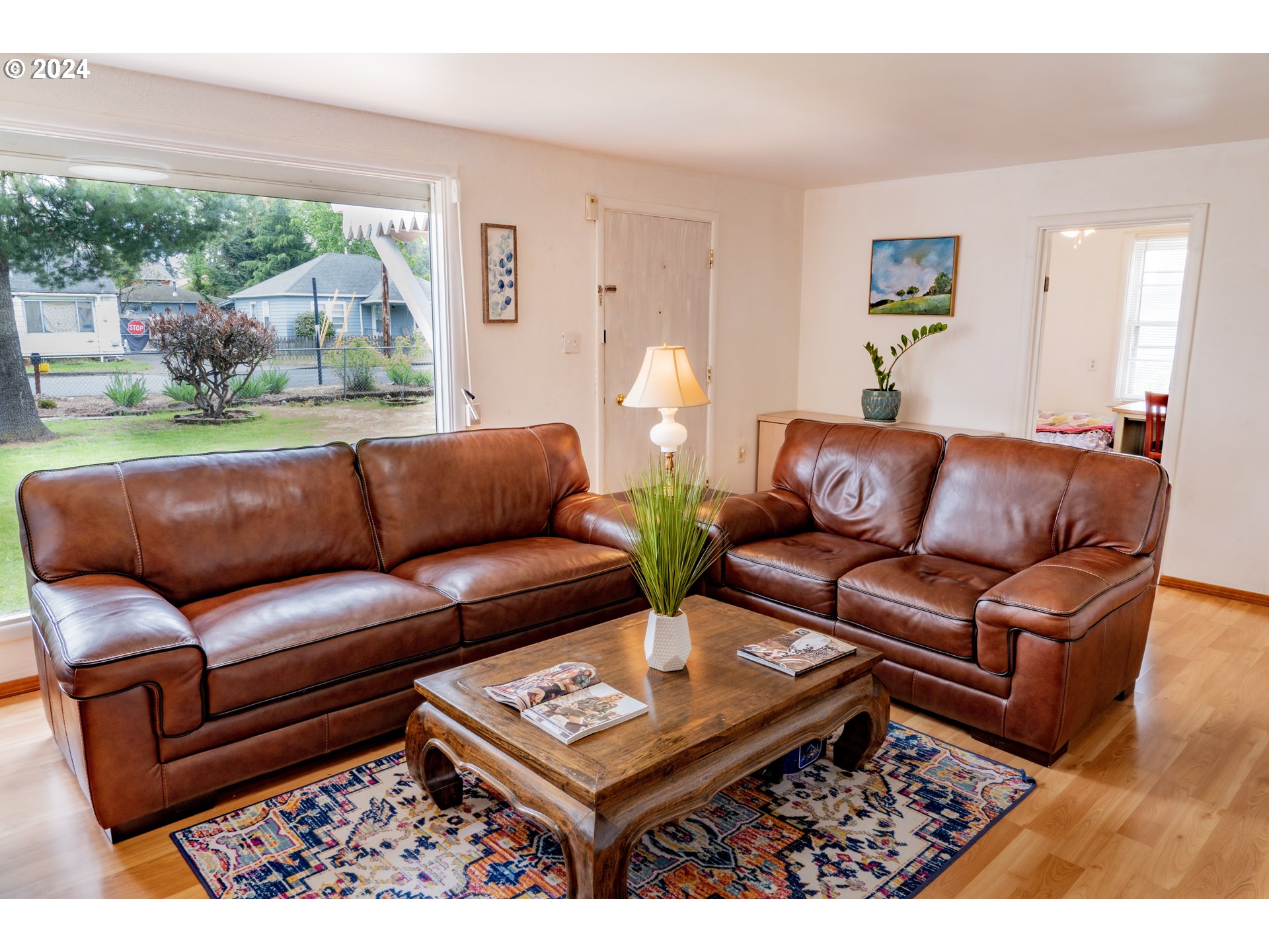 17141 Southeast Stephens Street Portland, OR 97233 - Photo 5 of 27 a living room with furniture a flat screen tv and a floor to ceiling window