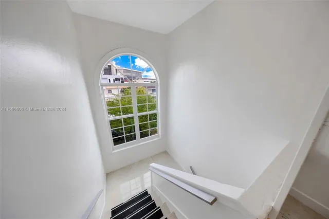 a view of room with window and stairs
