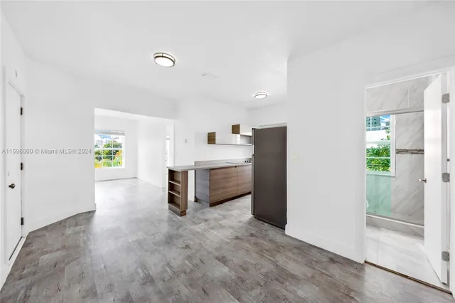 a view of a kitchen with furniture and an entryway