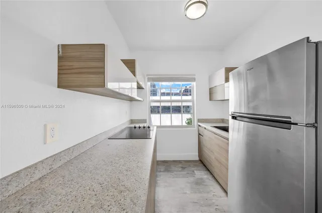a kitchen with a refrigerator and a stove