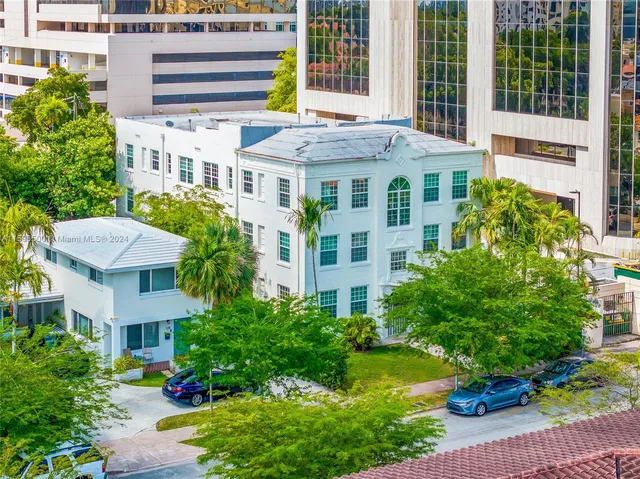 a aerial view of a residential apartment building with a yard