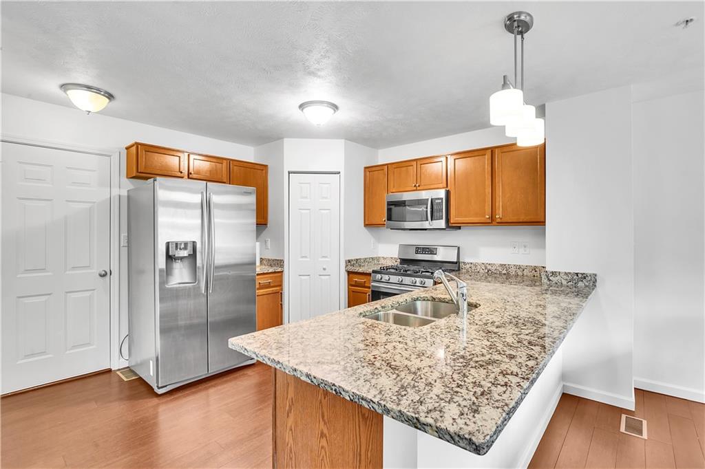 6439 Lindsey Lane Export, PA 15632 - Photo 17 of 39 a kitchen with stainless steel appliances granite countertop a sink and a refrigerator