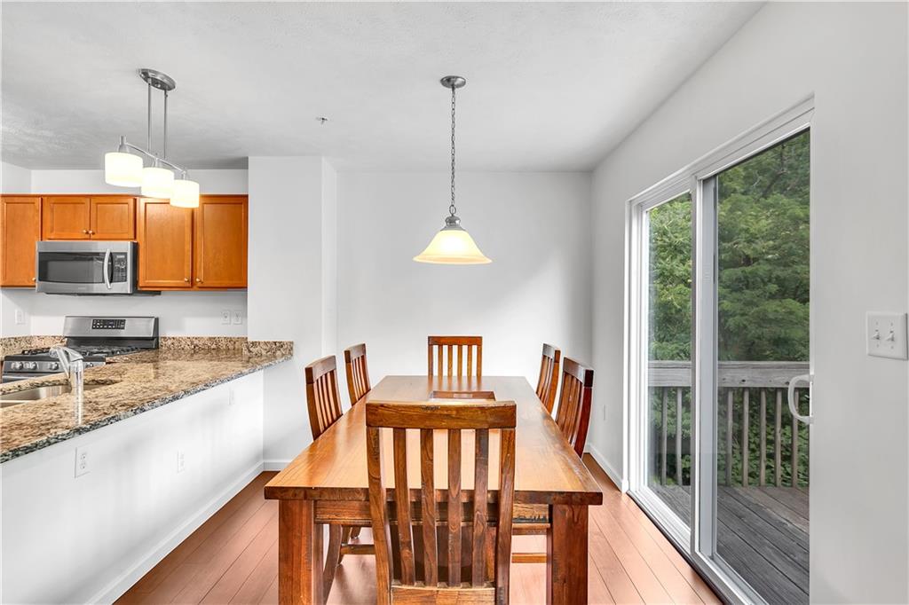 6439 Lindsey Lane Export, PA 15632 - Photo 21 of 39 a kitchen with stainless steel appliances granite countertop a stove a sink and a wooden floors