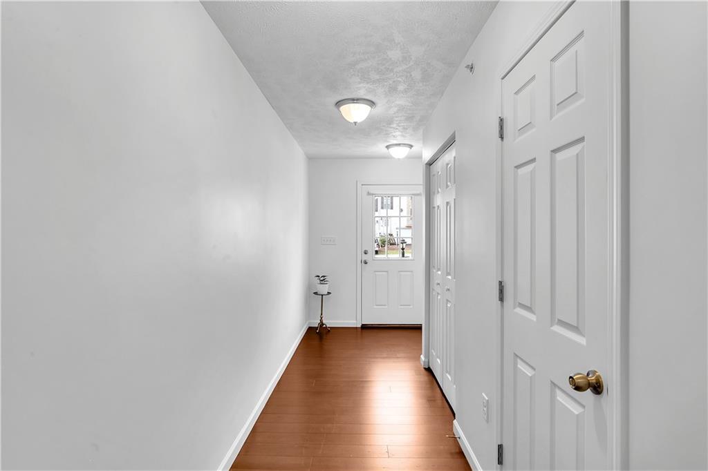 6439 Lindsey Lane Export, PA 15632 - Photo 7 of 39 a view of a hallway with wooden floor and a bathroom
