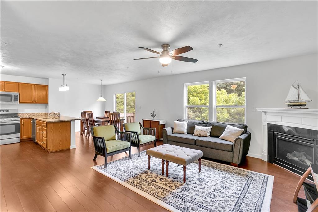 6439 Lindsey Lane Export, PA 15632 - Photo 10 of 39 a living room with fireplace furniture and a wooden floor
