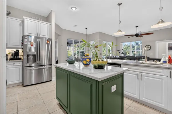 a kitchen with stainless steel appliances granite countertop a sink a stove and a refrigerator