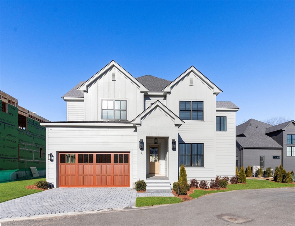 8 Common Court, Unit 8 Lexington, MA 02421 - Photo 1 of 17 a front view of a house with a yard