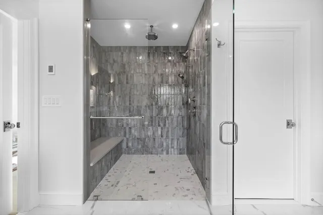 a bathroom with a glass shower door