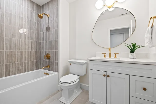 a bathroom with a sink a mirror a toilet and bathtub