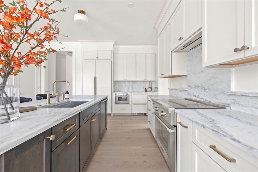 8 Common Court, Unit 8 Lexington, MA 02421 - Photo 4 of 17 a kitchen with a sink stove and cabinets