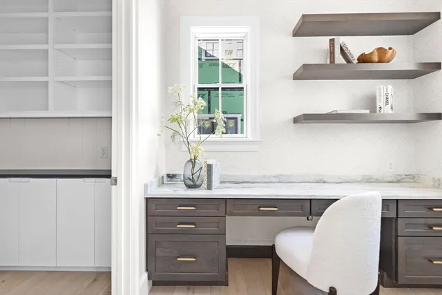 a kitchen with a sink a window and cabinets