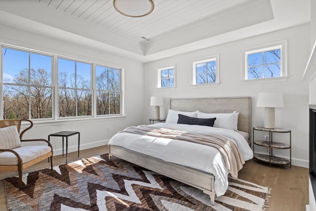8 Common Court, Unit 8 Lexington, MA 02421 - Photo 10 of 17 a bedroom with a bed a couch and large window