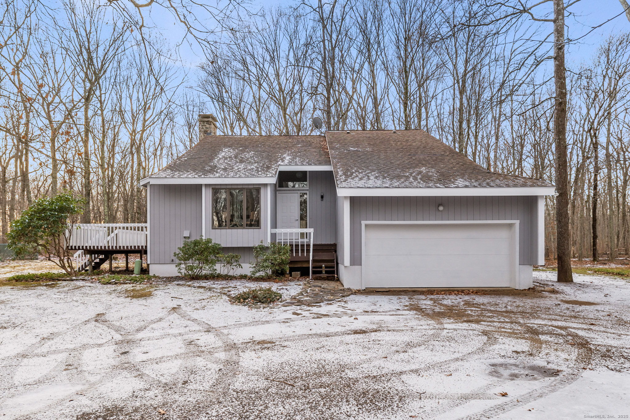 a front view of a house with a yard and seating space