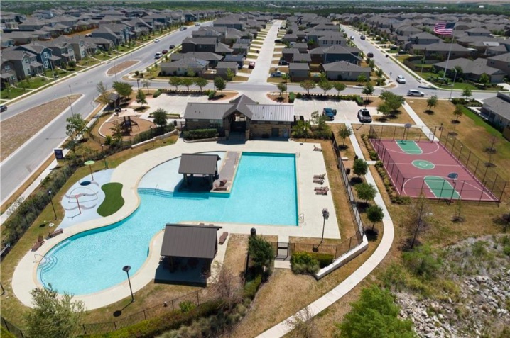 10805 Meris Lane Austin, TX 78754 - Photo 28 of 28 An aerial perspective reveals a vibrant community with recreational amenities and residential streets.