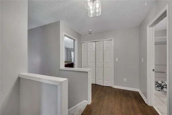 a view of a hallway with entryway wooden floor and chandelier