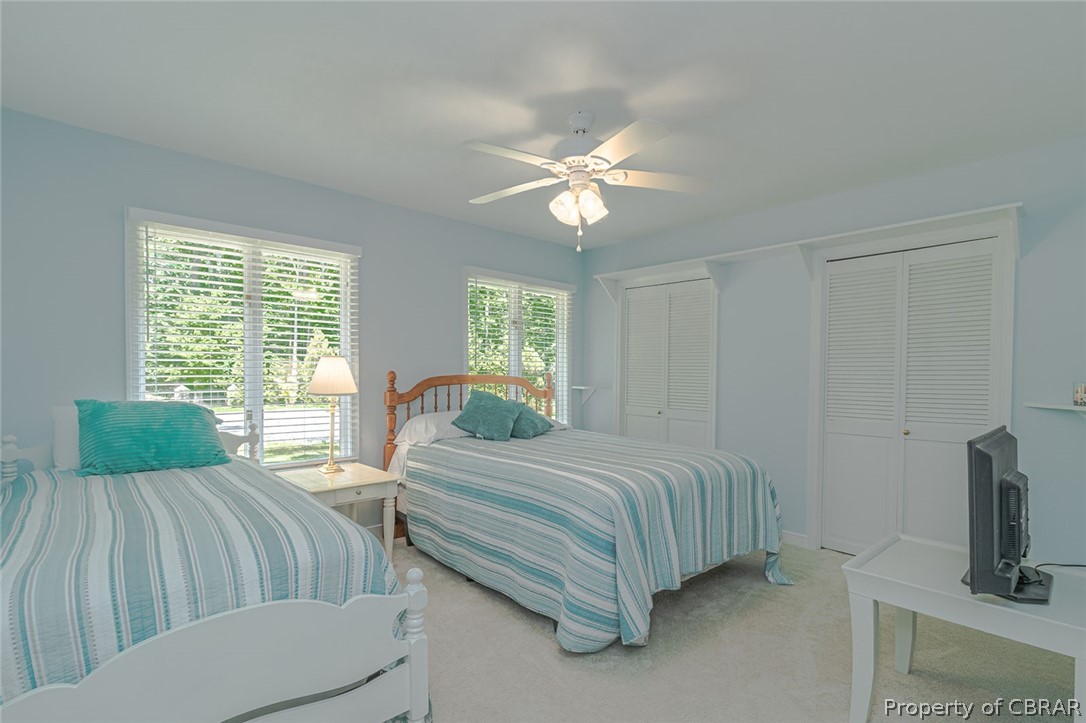 988 Queenstown Road Lancaster, VA 22503 - Photo 23 of 37 a bedroom with a bed and a chandelier